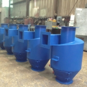 Row of fabricated blue cyclone dust collectors lined up in a workshop. Row of fabricated blue cyclone dust collectors lined up in a workshop.