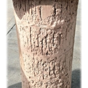 Close-up of a cylindrical industrial dust collector filter cartridge caked with thick buildup and residue Close-up of a cylindrical industrial dust collector filter cartridge caked with thick buildup and residue