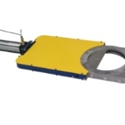 Pneumatically actuated slide gate valve with a yellow protective guard used for automated material flow control. Pneumatically actuated slide gate valve with a yellow protective guard used for automated material flow control.